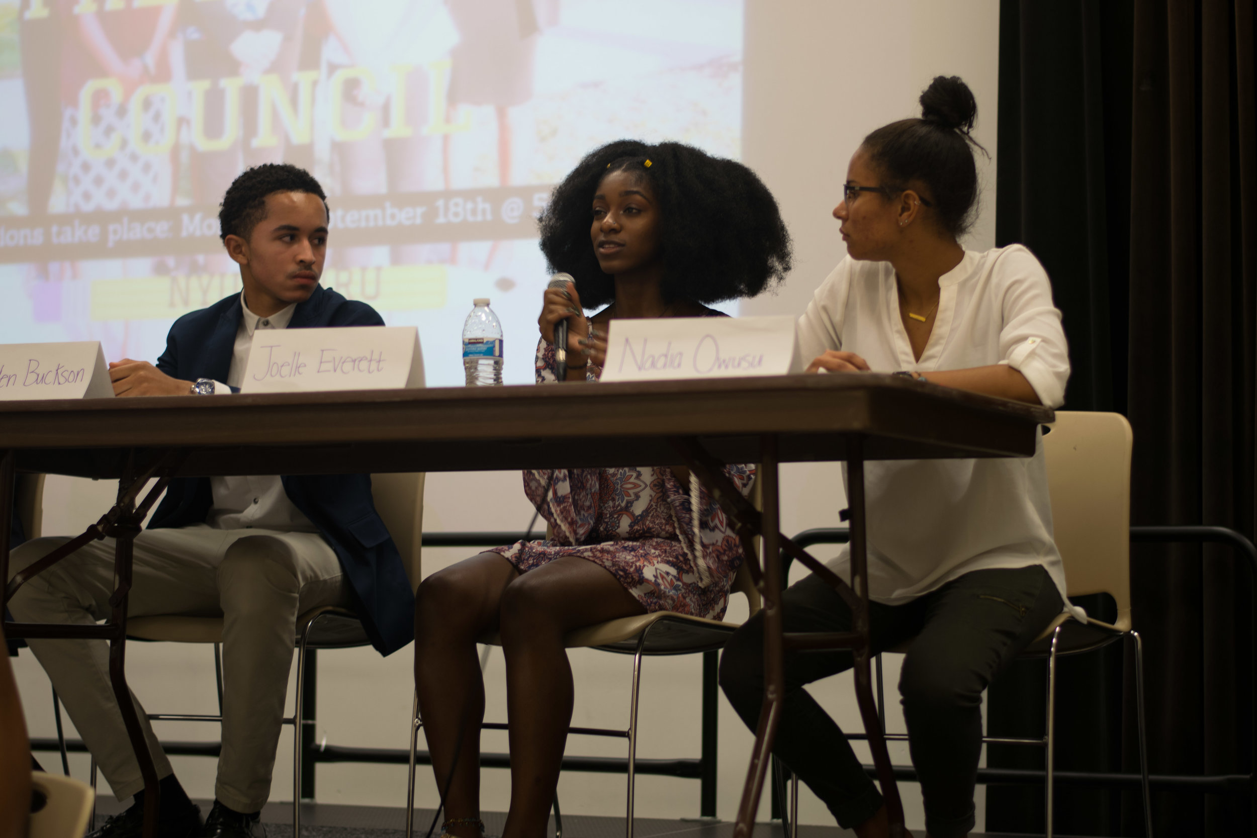 Landen Buckson (left), Joelle Everett (middle), and Nadia Owusu (right) answer a question from an audience member at the 2017-2018 Black Student Union Freshman Council elections on Monday, Sept. 18, 2017. This person asked what is one goal the candi&hellip;