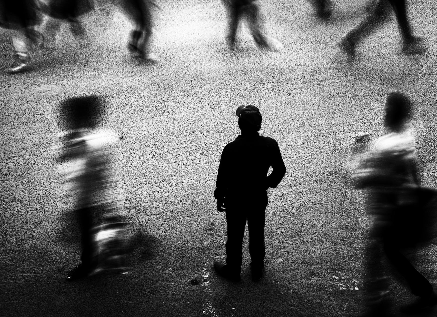 people on a crowded street in black and white